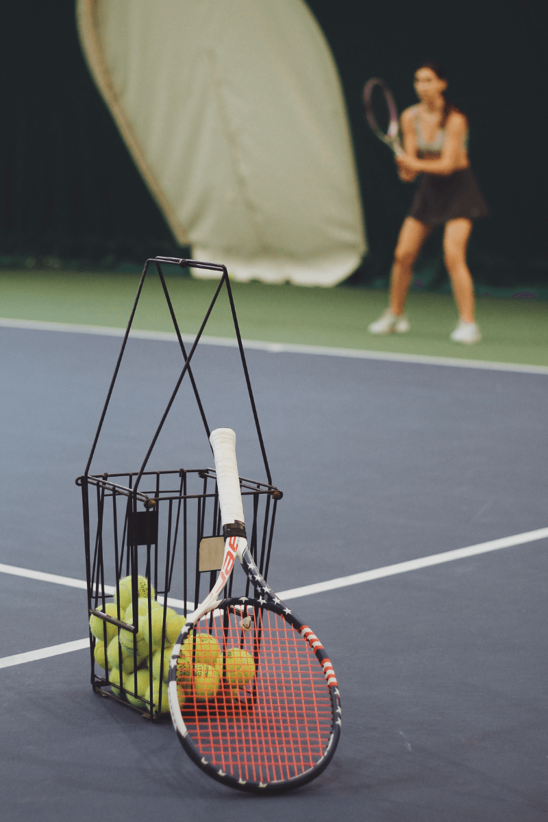woman taking tennis lesson